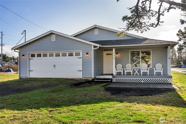 a front view of a house with a yard and fence