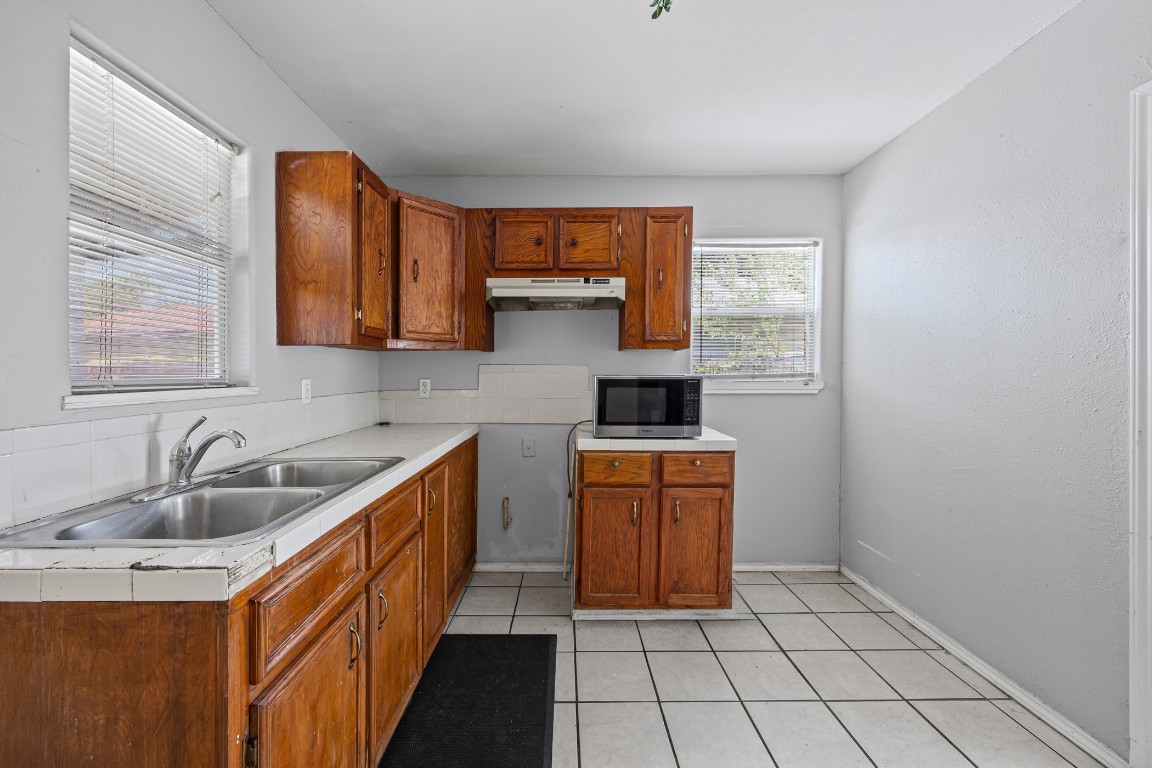 908 Vargas Road Austin, TX 78741 - Photo 15 of 28 a kitchen with stainless steel appliances a sink stove and cabinets