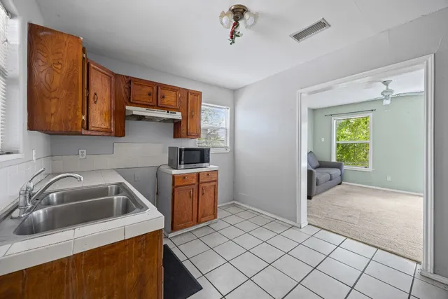 a kitchen with a sink cabinets and utility