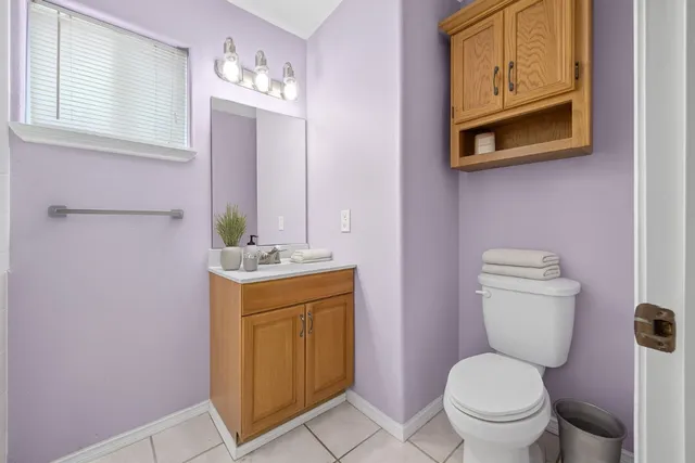 a bathroom with a sink a toilet and mirror