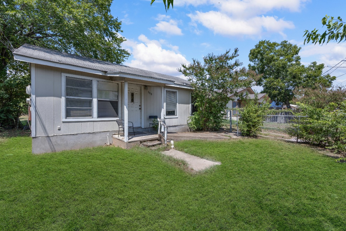 908 Vargas Road Austin, TX 78741 - Photo 4 of 28 a view of a backyard with table and chairs and potted plants and large tree