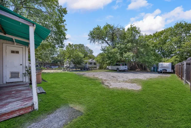 a view of a backyard with large trees