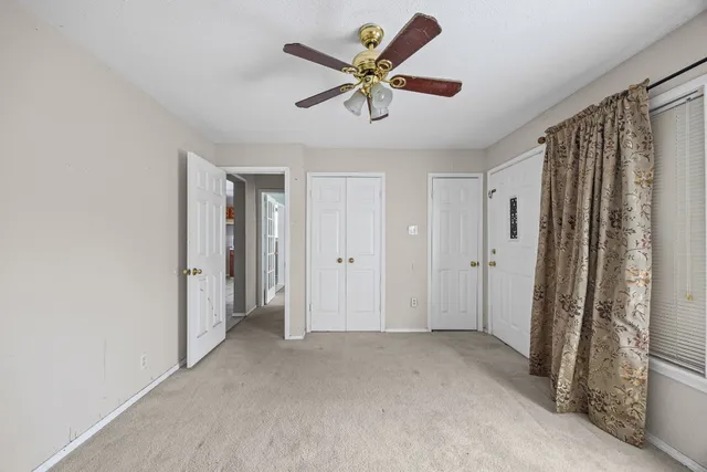 a view of an empty room with a ceiling fan