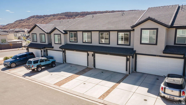 1693 Devils Gdn Lane Washington, UT 84780 - Photo 59 of 64 Multi-unit property featuring contemporary stucco exteriors with dark trim, individual garages, and concrete driveways