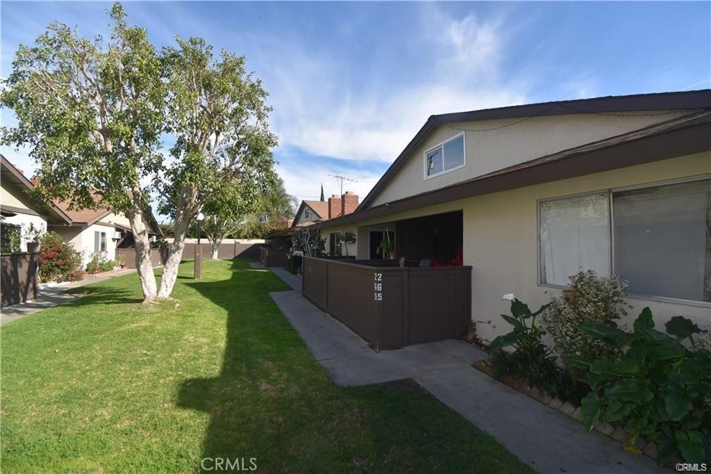 9155 Pacific Avenue, Unit 265 Anaheim, CA 92804 - Photo 15 of 18 a front view of a house with a yard