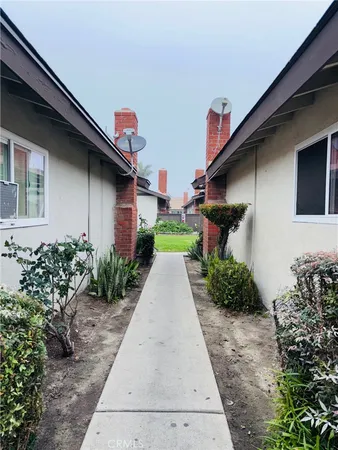a pathway of a house with a yard