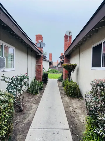 a pathway of a house with a yard