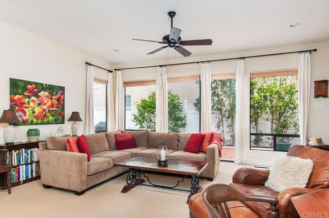 a living room with furniture a rug and a large window
