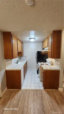 a kitchen with stainless steel appliances wooden cabinets and a sink