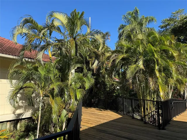 a view of backyard with outdoor seating and trees