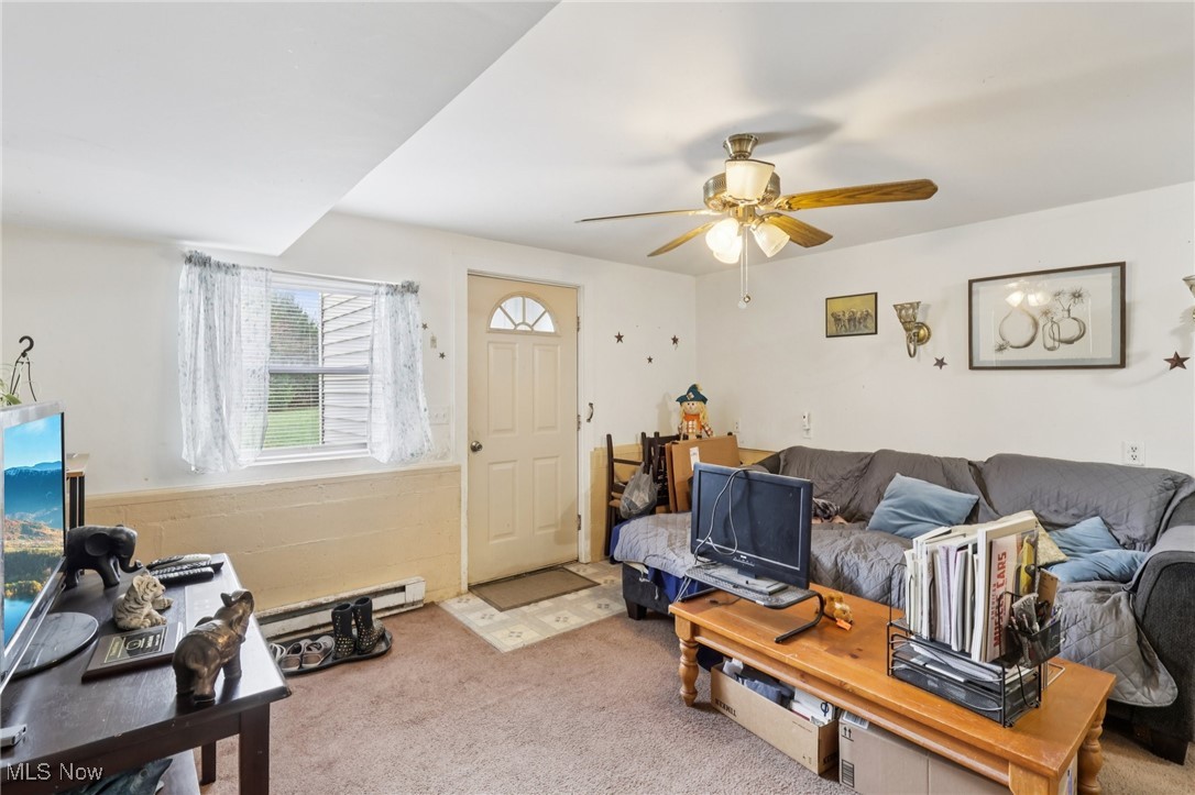 6370 Trumbull Road Geneva, OH 44041 - Photo 28 of 50 Living room with a baseboard heating unit, carpet flooring, and ceiling fan