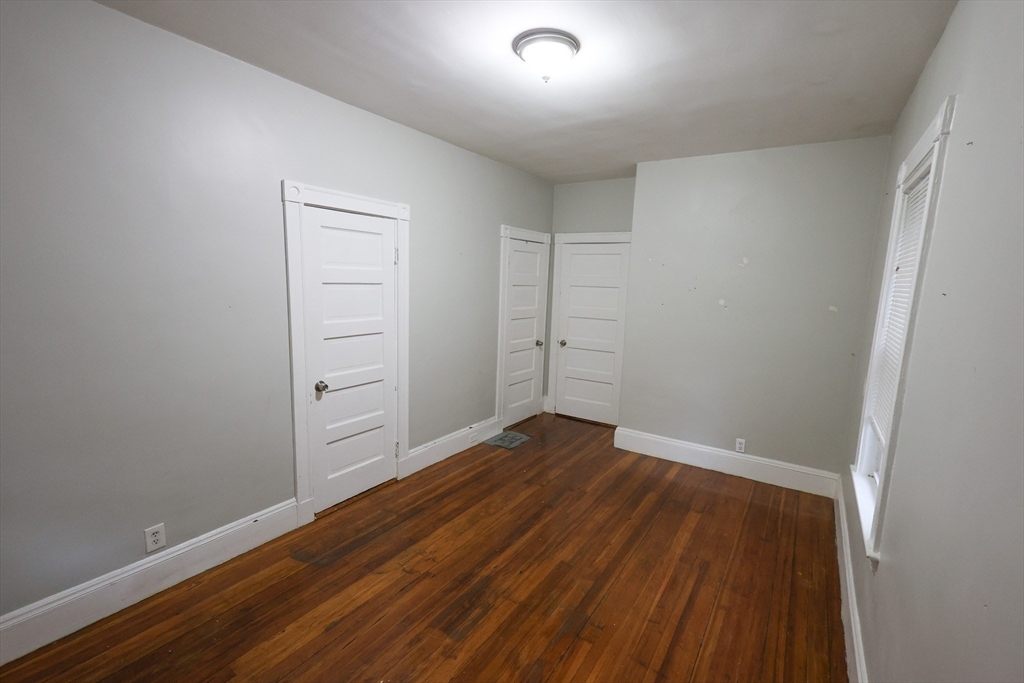 82 Fuller Street, Unit 1 Boston, MA 02124 - Photo 13 of 13 wooden floor in an empty room