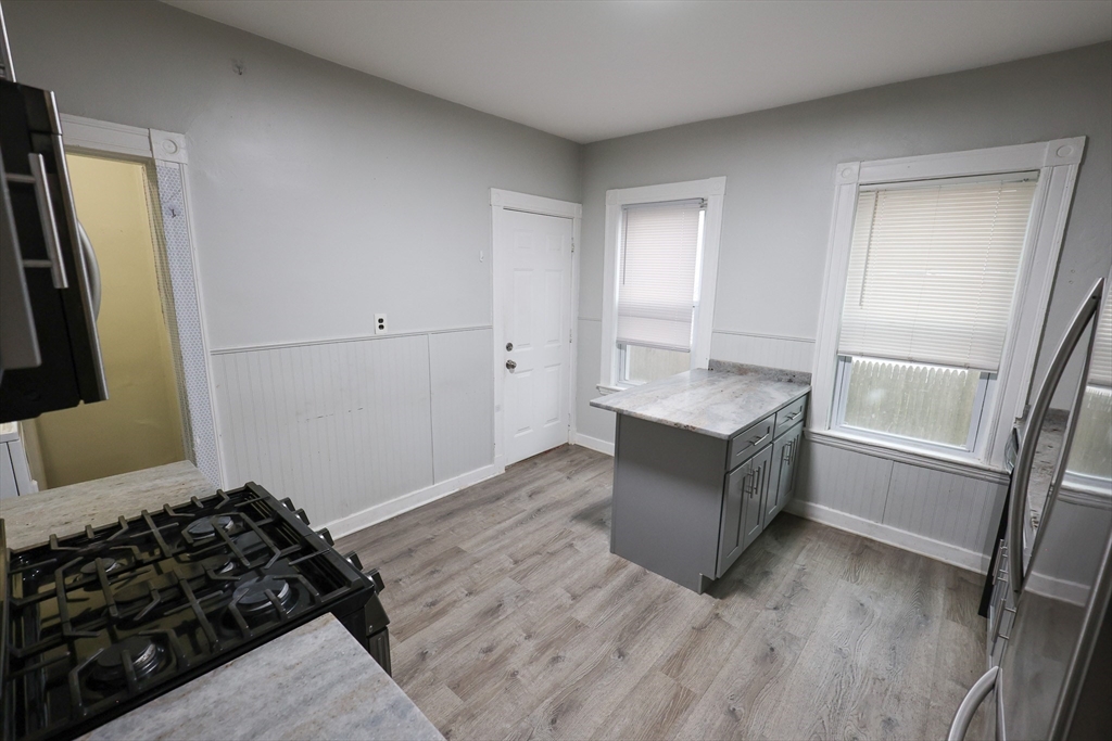 82 Fuller Street, Unit 1 Boston, MA 02124 - Photo 2 of 13 a living room with a couch and a window
