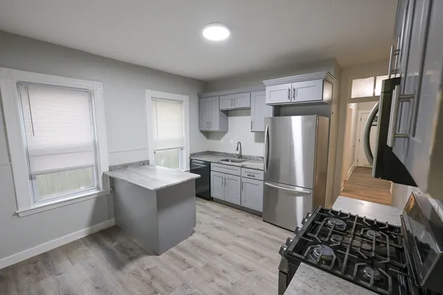 a kitchen with a refrigerator and a sink