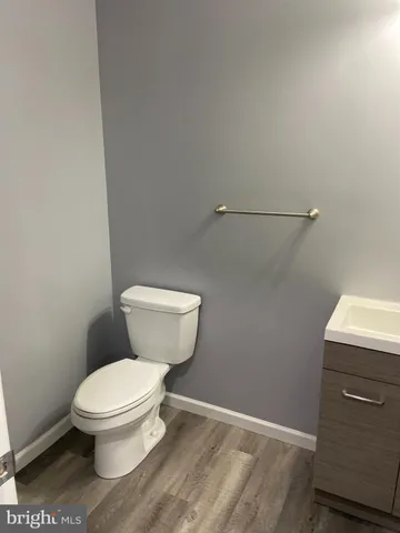 a white toilet sitting next to a small bathroom