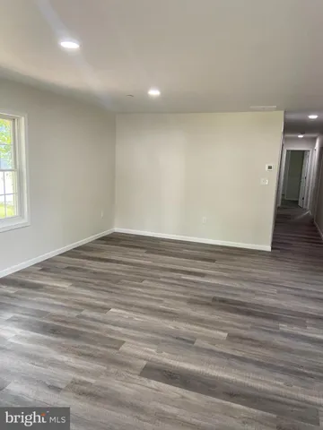 a view of room with window and wooden floor