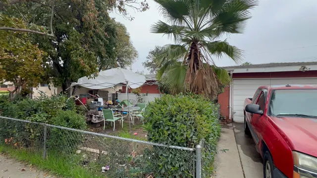 a view of swimming pool with a table and chairs under an umbrella