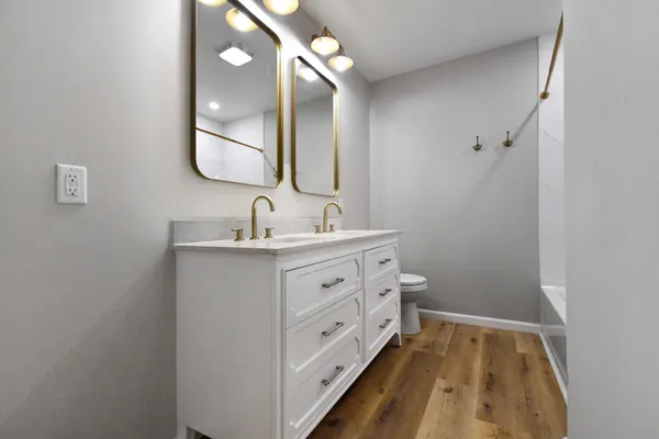 a bathroom with a double vanity sink and mirror