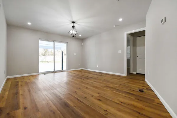 wooden floor in an empty room with a window