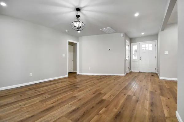 a view of an empty room and wooden floor