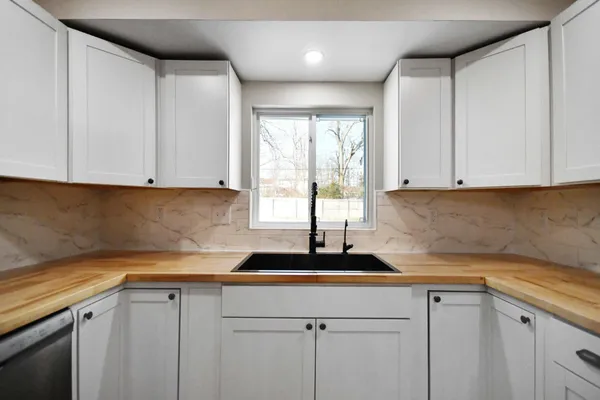 a kitchen with a sink and cabinets