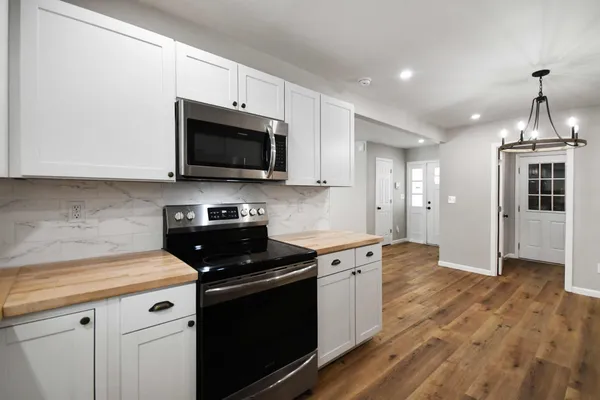 a kitchen with a stove and a microwave