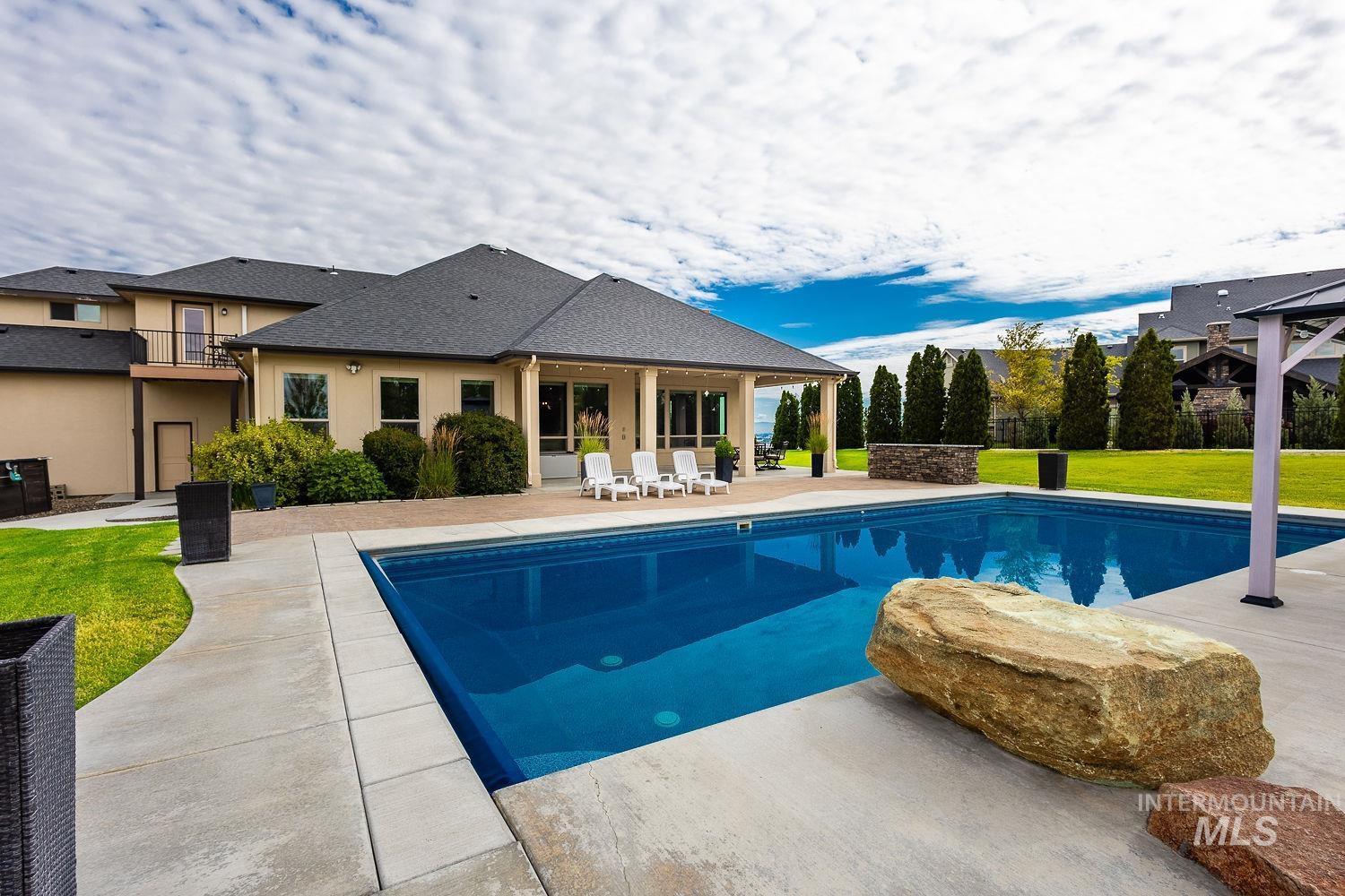 8077 Star Pass Ridge Road Nampa, ID 83686 - Photo 6 of 37 Expansive rectangular swimming pool with concrete surround