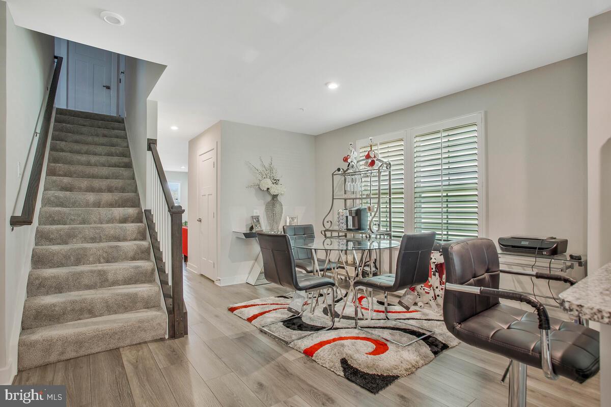 14304 Longhouse Loop, Unit A Brandywine, MD 20613 - Photo 12 of 72 a living room with furniture and floor to ceiling windows