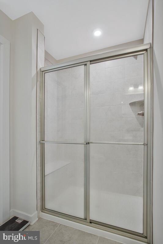 14304 Longhouse Loop, Unit A Brandywine, MD 20613 - Photo 20 of 72 a bathroom with a glass shower door