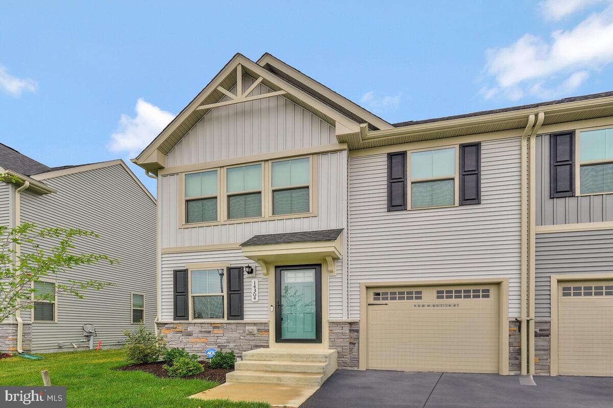 14304 Longhouse Loop, Unit A Brandywine, MD 20613 - Photo 2 of 72 a front view of a house with garden