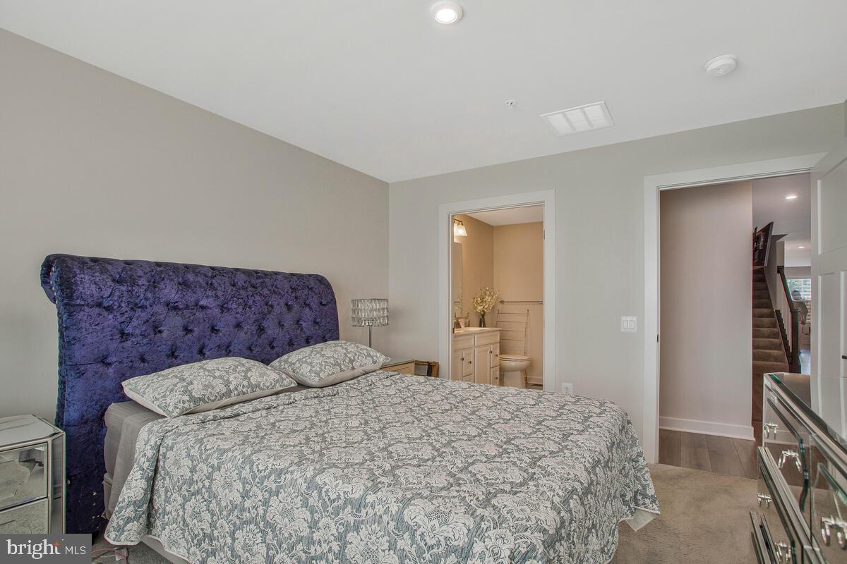 14304 Longhouse Loop, Unit A Brandywine, MD 20613 - Photo 22 of 72 a bedroom with a bed and a walk in closet