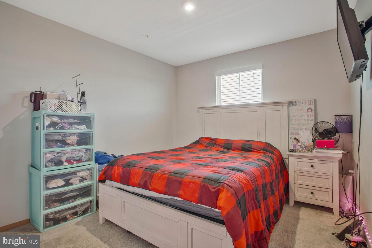 14304 Longhouse Loop, Unit A Brandywine, MD 20613 - Photo 24 of 72 a bedroom with a bed and dresser