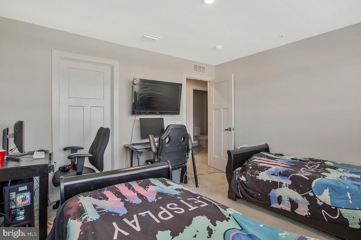 14304 Longhouse Loop, Unit A Brandywine, MD 20613 - Photo 28 of 72 a bedroom with a bed and a flat screen tv