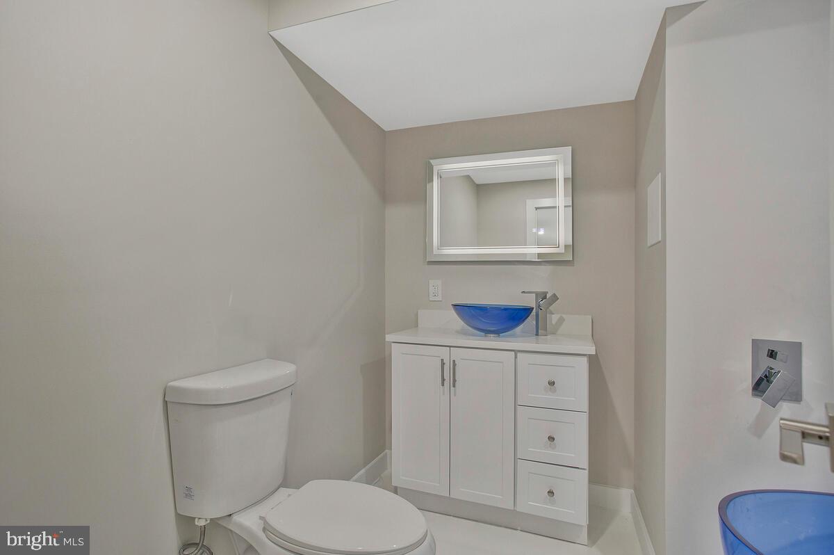 14304 Longhouse Loop, Unit A Brandywine, MD 20613 - Photo 31 of 72 a bathroom with a toilet a sink and a mirror
