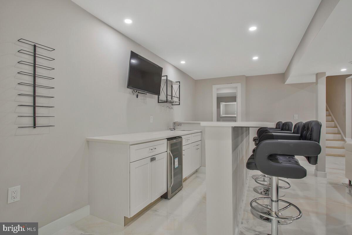 14304 Longhouse Loop, Unit A Brandywine, MD 20613 - Photo 33 of 72 a kitchen with stainless steel appliances kitchen island granite countertop a sink and a refrigerator