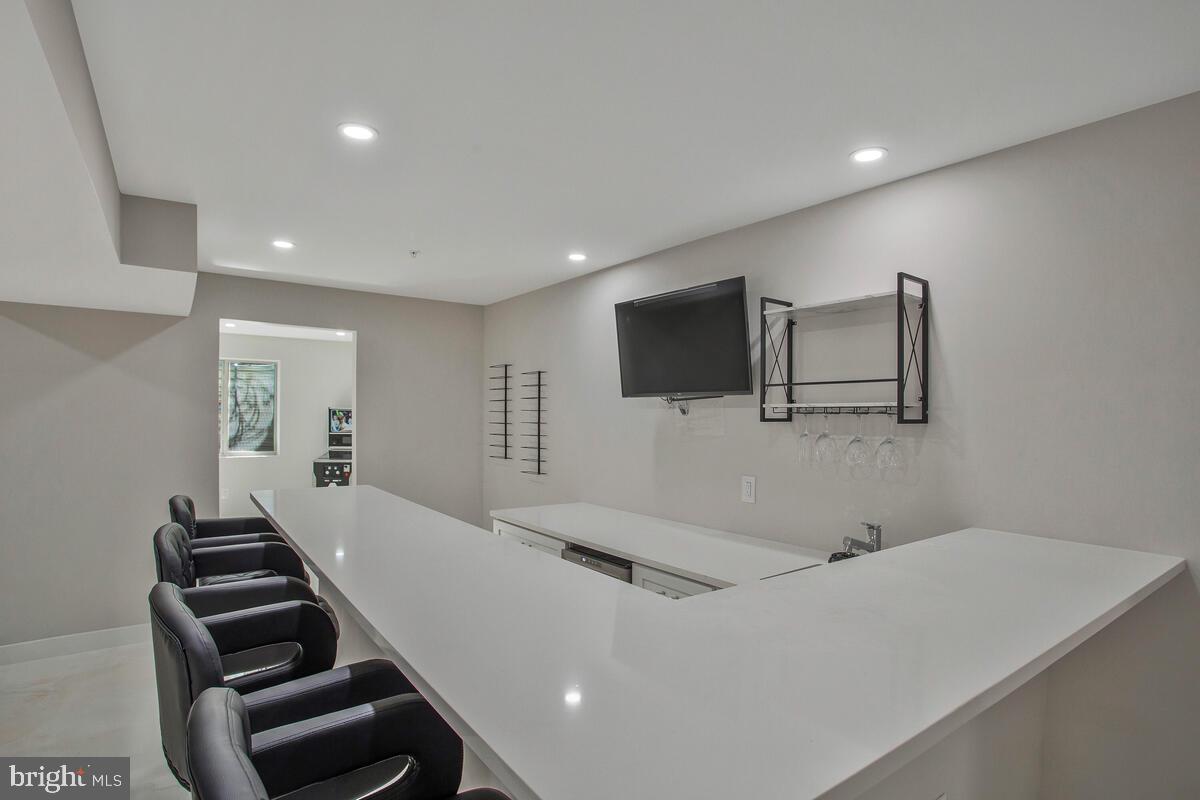 14304 Longhouse Loop, Unit A Brandywine, MD 20613 - Photo 35 of 72 a living room with furniture and a flat screen tv