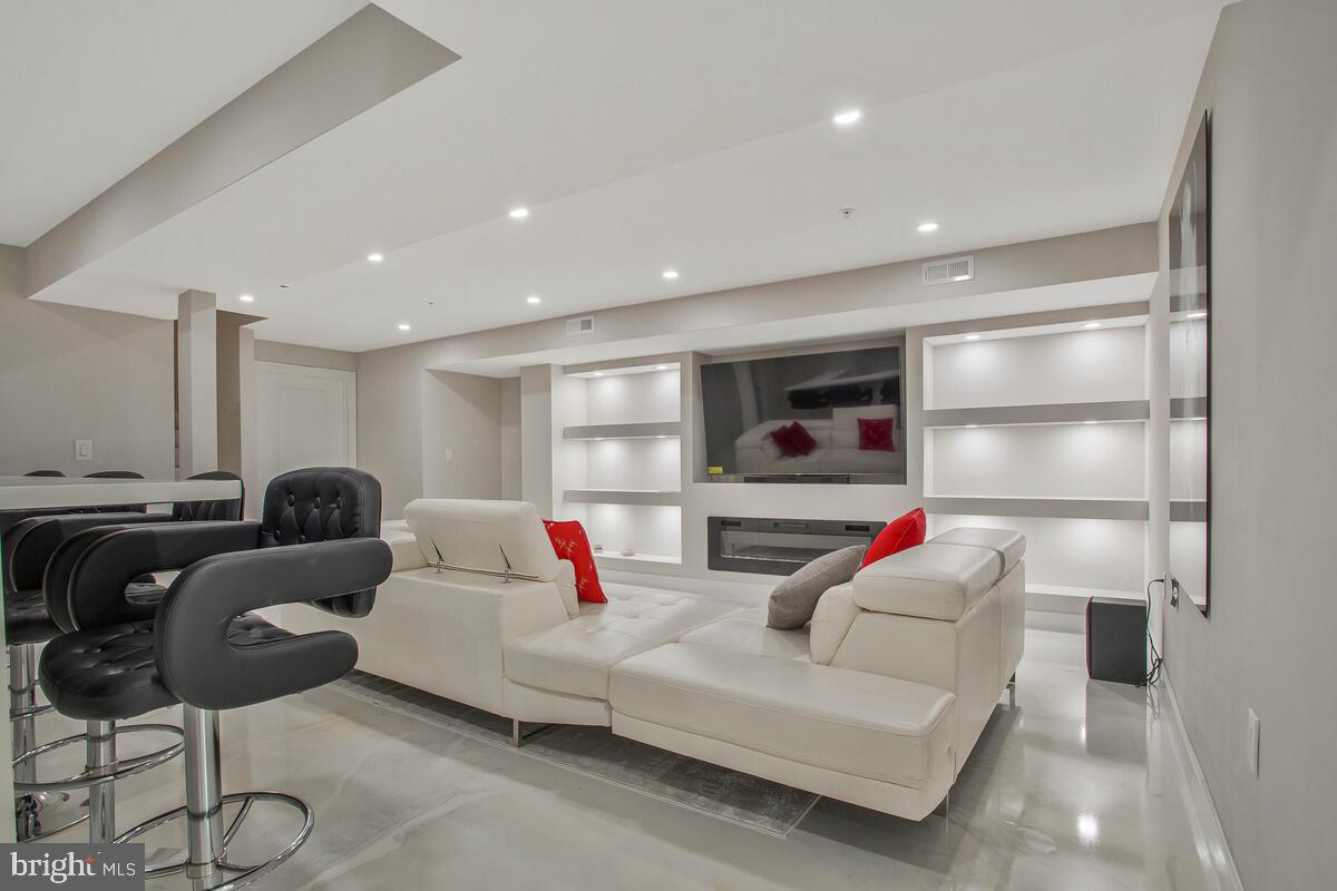 14304 Longhouse Loop, Unit A Brandywine, MD 20613 - Photo 36 of 72 a living room with furniture and a flat screen tv