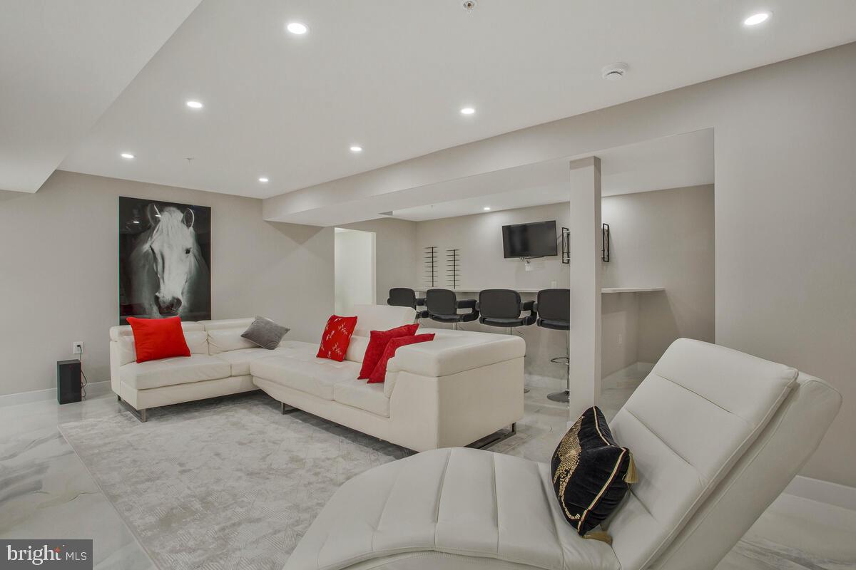 14304 Longhouse Loop, Unit A Brandywine, MD 20613 - Photo 39 of 72 a living room with furniture and a couch