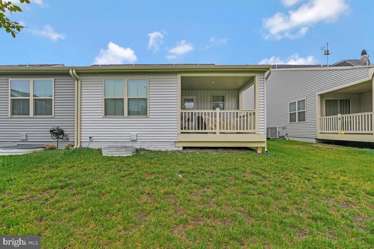 14304 Longhouse Loop, Unit A Brandywine, MD 20613 - Photo 42 of 72 a front view of a house with a garden
