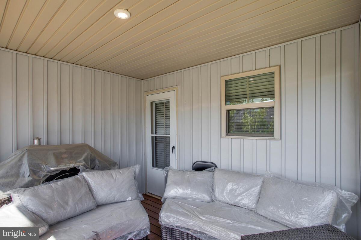 14304 Longhouse Loop, Unit A Brandywine, MD 20613 - Photo 44 of 72 a living room with furniture and a window