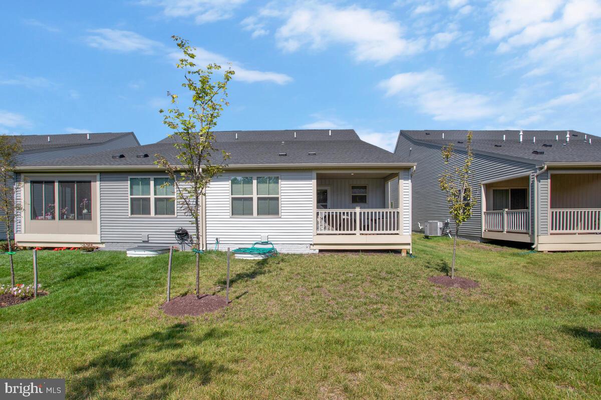 14304 Longhouse Loop, Unit A Brandywine, MD 20613 - Photo 46 of 72 a front view of a house with a garden