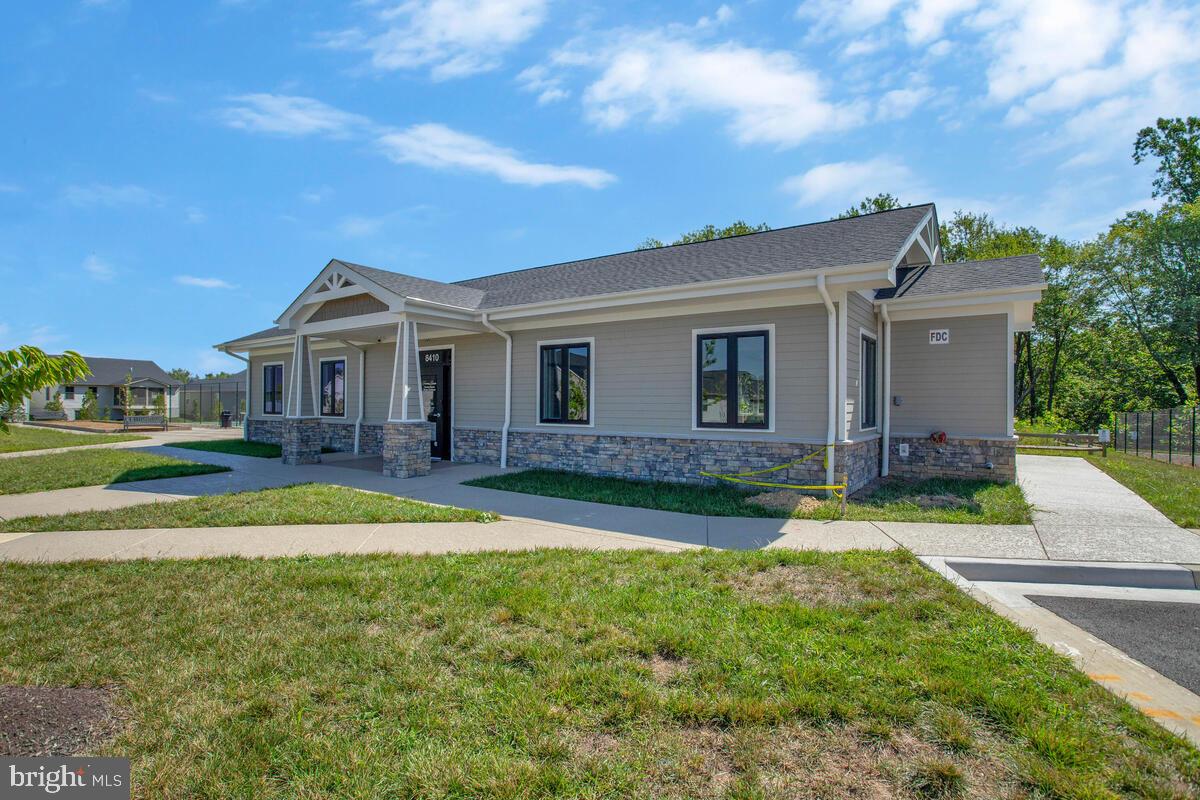 14304 Longhouse Loop, Unit A Brandywine, MD 20613 - Photo 50 of 72 a view of a house with a swimming pool and a yard