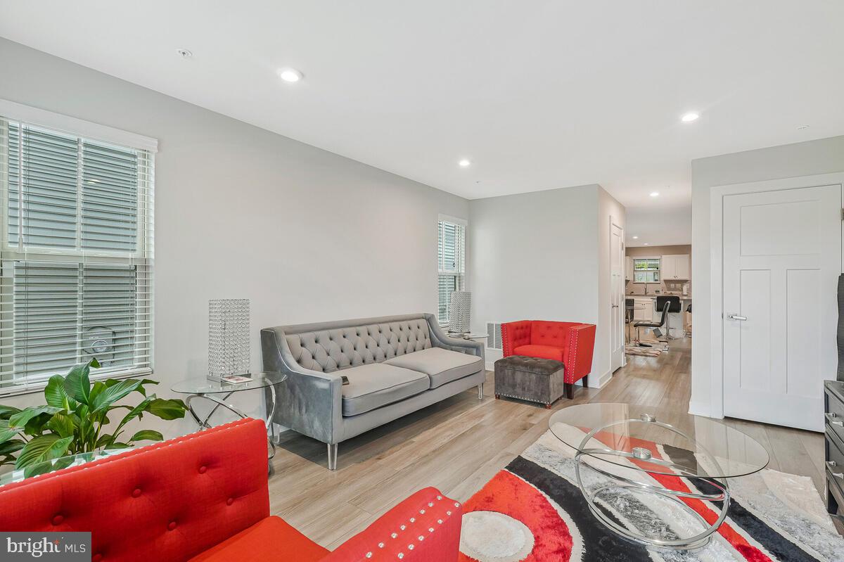 14304 Longhouse Loop, Unit A Brandywine, MD 20613 - Photo 54 of 72 a living room with furniture and a potted plant