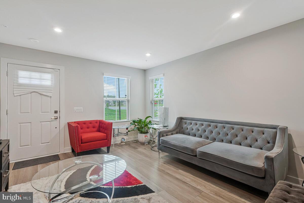 14304 Longhouse Loop, Unit A Brandywine, MD 20613 - Photo 55 of 72 a living room with furniture and a couch