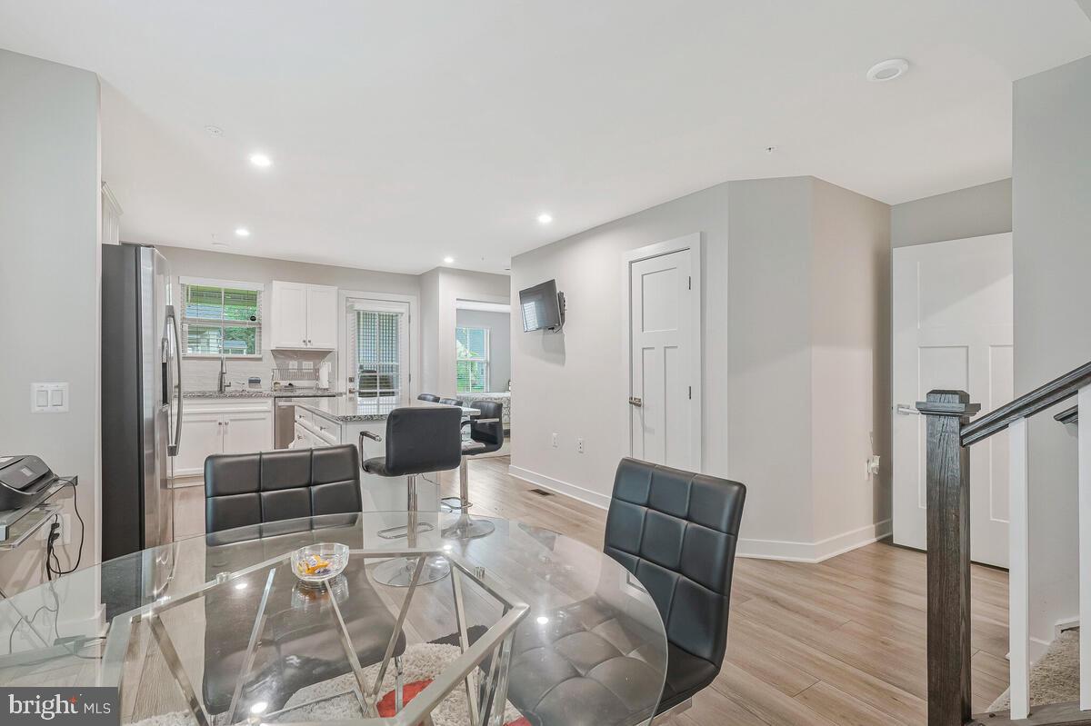 14304 Longhouse Loop, Unit A Brandywine, MD 20613 - Photo 57 of 72 a living room with furniture wooden floor and a table