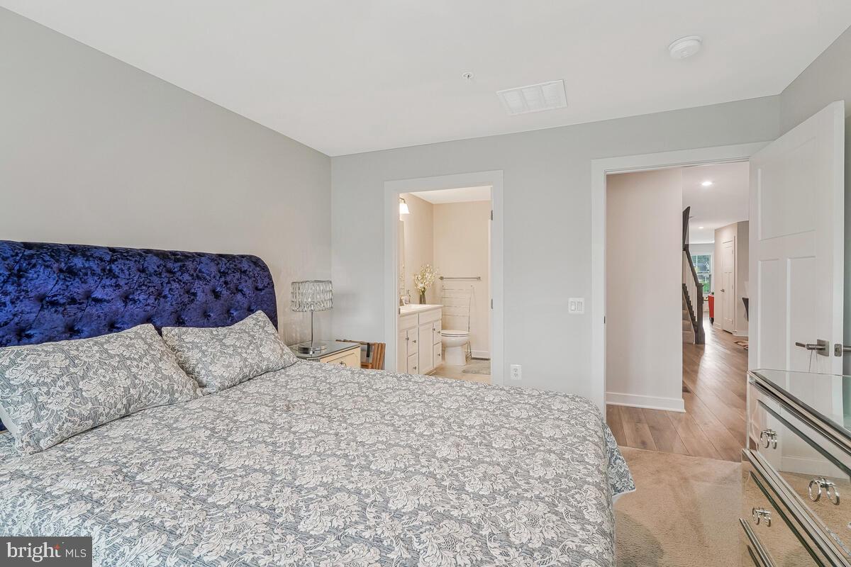 14304 Longhouse Loop, Unit A Brandywine, MD 20613 - Photo 66 of 72 a bedroom with a large bed and a couch