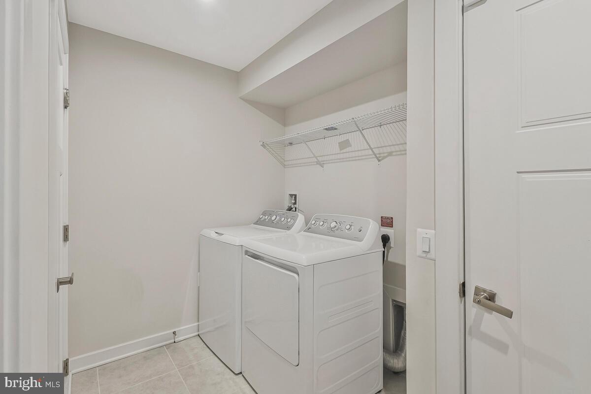 14304 Longhouse Loop, Unit A Brandywine, MD 20613 - Photo 69 of 72 a utility room with cabinets washer and dryer