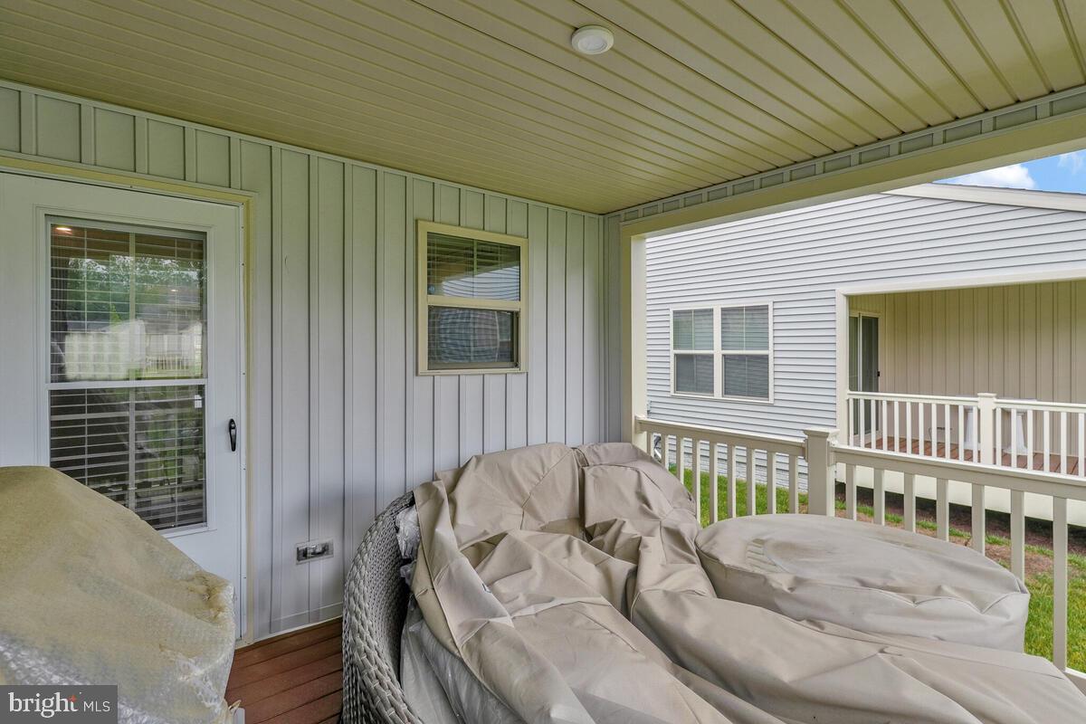 14304 Longhouse Loop, Unit A Brandywine, MD 20613 - Photo 72 of 72 a view of a deck with couches with wooden floor and fence