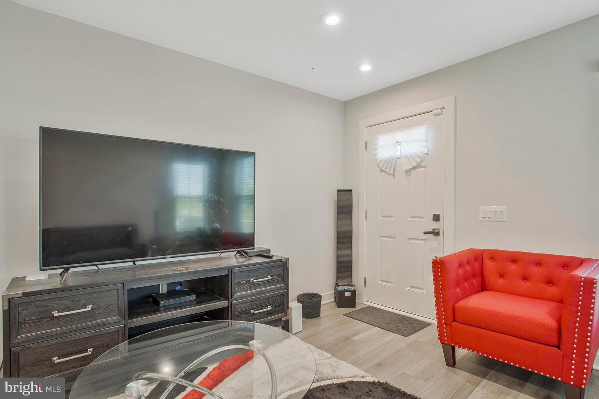 14304 Longhouse Loop, Unit A Brandywine, MD 20613 - Photo 8 of 72 a living room with furniture and a flat screen tv