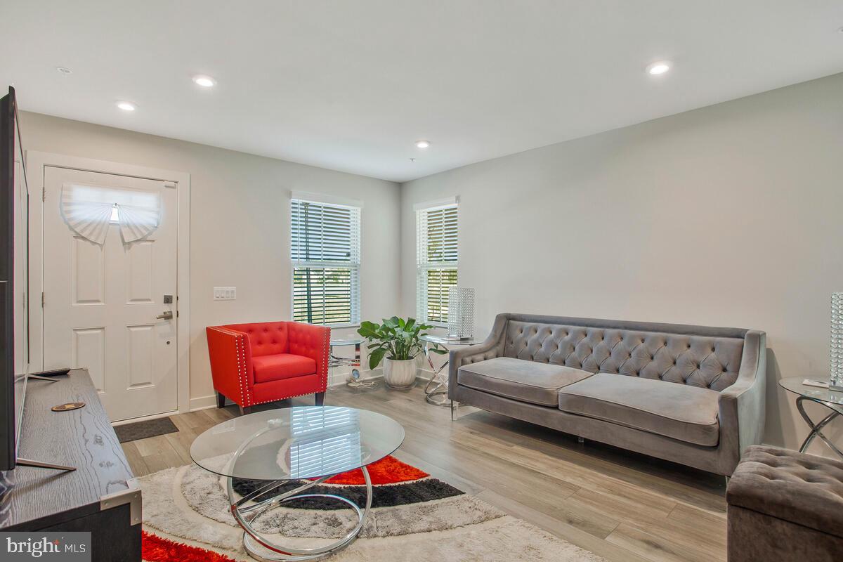 14304 Longhouse Loop, Unit A Brandywine, MD 20613 - Photo 9 of 72 a living room with furniture and a couch